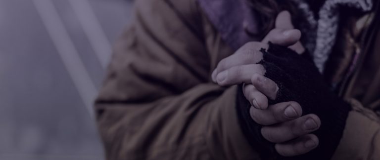 A person wrings their hands in a sepia-toned photo.