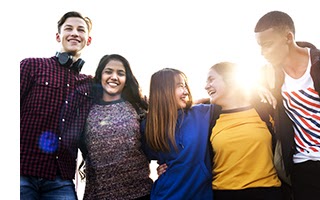 Group of school friends outdoors arms around one another togetherness and community concept