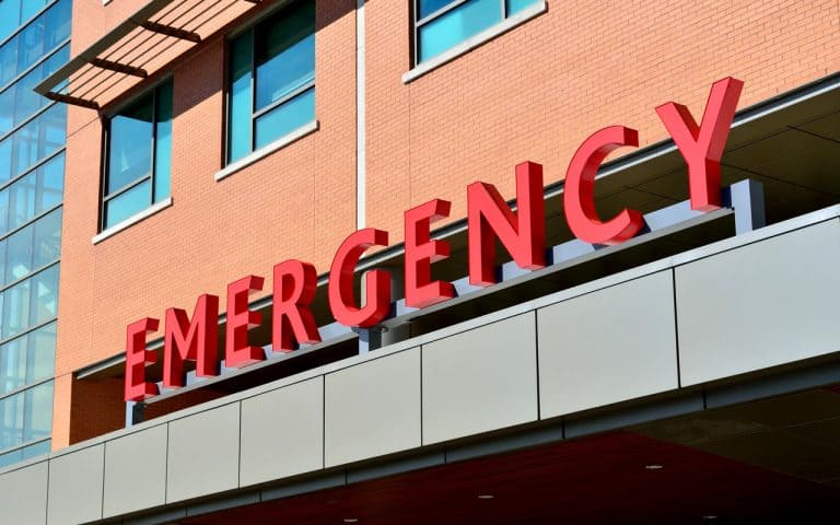 Picture of a red Emergency Room sign at a hospital