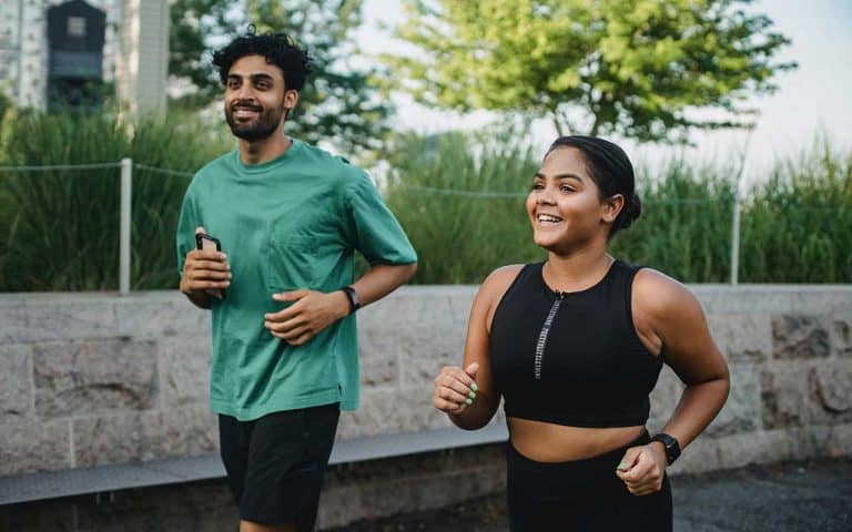 A femme and a masc-presenting person go for a run outside.