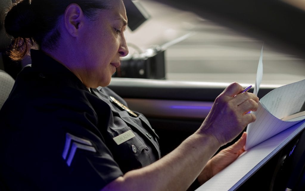 Police officer looking over paperwork