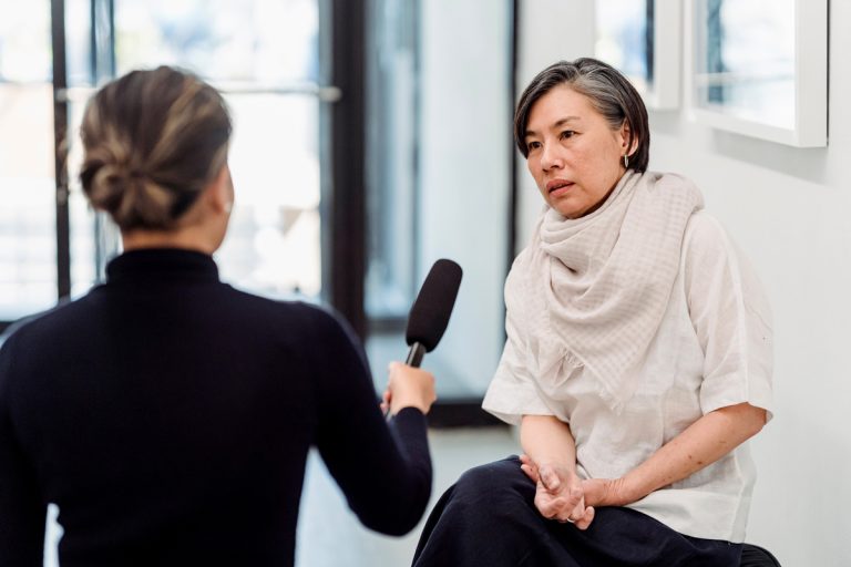 A women being presented with a microphone