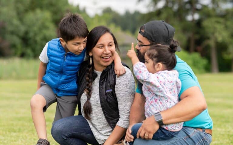 A Native American family outdoors together.