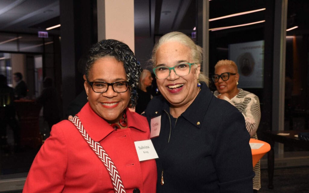Sabrina and Cynthia, guests at Celebrating Allies, smile together for a photo.