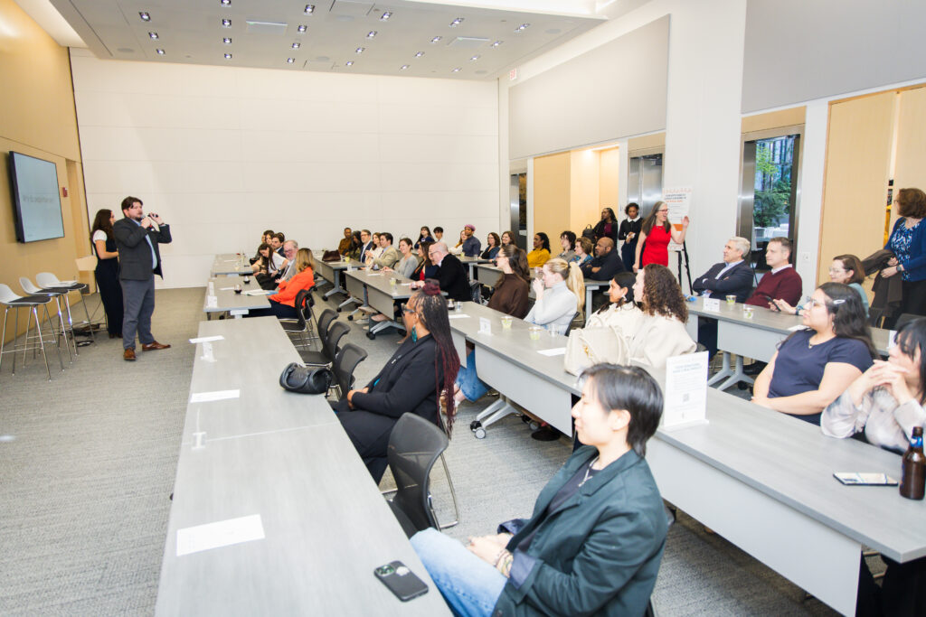 Photo showing a room of participants listening at A CAASE of Empowerment 2026