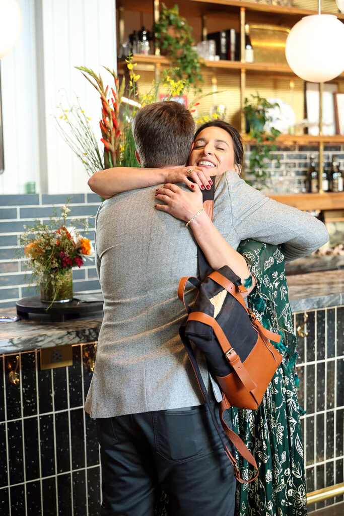Two guest at Provenance hug.