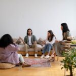 A small group of people sit and talk with each other.
