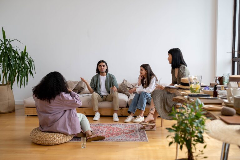 A small group of people sit and talk with each other.